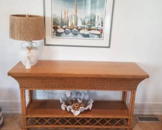 Rattan foyer table; table lamp; sailboat art