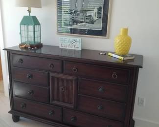 Rattan dresser; table lamp; artwork