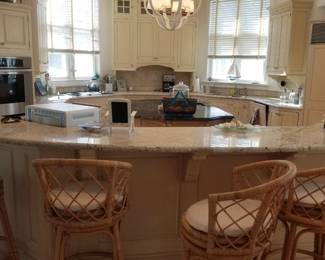 Wood-Mode kitchen with an island. Serena & Lily bar stools