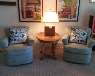 Cozy pale green swivel chairs; table; table lamp