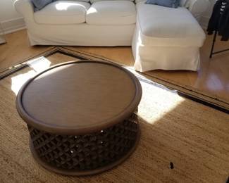 White slipcovered sofa with chaise; Serena & Lily Bamileke drum coffee table; area rug