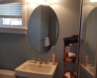 Pedestal sink; mirror; vanity lights