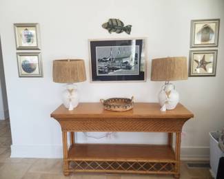 Rattan foyer table; table lamps; nautical and shell art