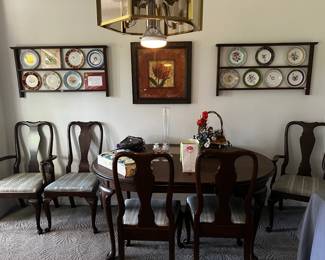 Lovely dining room set w/6 chairs, leaf and protective table cover. On wall - Presidential Collectors plates