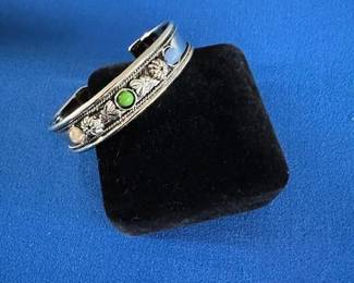 Silver tone cuff bracelet with accent stones.