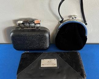 Black textured box clutch with multi stone knuckle ring handle, small velvet bag and JM New York leather clutch.