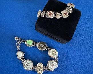 Silver toned charm link bracelets.
