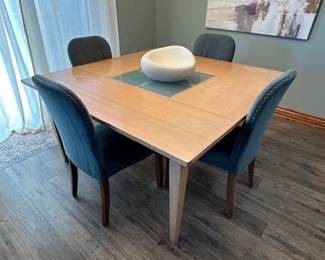 Square Wooden Dining Table with a central glass insert.  Check out the wheeled legs on the next photo. Table has a few blemishes.