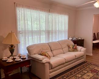 Leather couch, nice rug, end table with Shelley cups & saucers, nice lamp