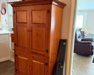 Armoire, pretty items up top, guitar