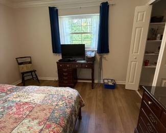 King bed, desk, TV. Hitchcock chair, vintage train case