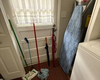 Mops, ironing board, umbrellas 