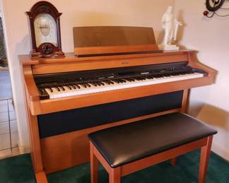 Roland KR-770 Digital Intelligent Piano – Full-size 88-key digital piano in beautiful wood cabinet. Includes matching piano bench/chair and original instruction manuals. In working condition with numerous sounds, rhythms and features.