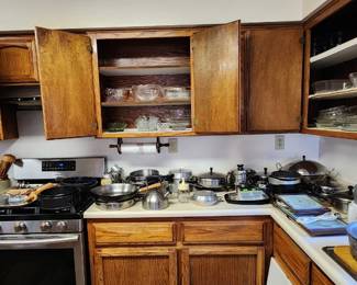 Cookware Galore! – Huge assortment of pots, pans, skillets, saucepans, baking dishes, lids, kitchen utensils and more. Cabinets are packed with dishes, glassware and everyday kitchen essentials. Lots to choose from!