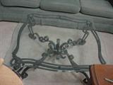 Large glass top Coffee table with heavy wrought iron base.