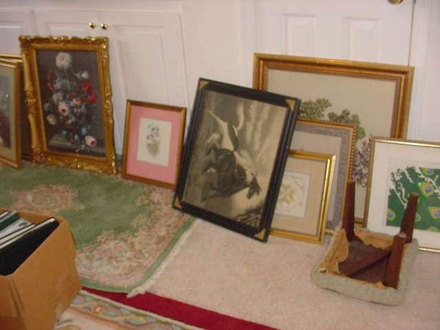 There are approximately 100 art pieces...some original oils, watercolors, several old needlepoints, old posters, , old photographs, textiles, etc.