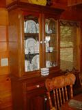 Double door china cabinet filled with beautiful set of china
