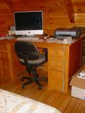 Compact wooden desk, with complete computer set up.
