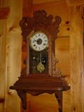 Antique wall clock. There is also a fine antique mantle clock as well.