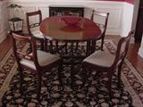 Beautiful oval dining room table...there are 4 chairs pictured as there is a kitchenette table that has 4 more chairs pictured elsewhere..can be sold with 4, or 8 chairs.