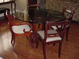 Kitchenette glass table, showing with th 4 chairs that match the dining room table.