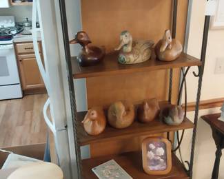 carved wooden ducks, wood and iron shelf