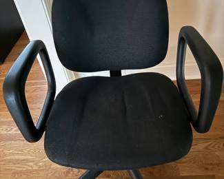 Black Upholstered Swivel Office Chair: comfortable black fabric office/desk chair with padded seat and back, molded armrests, adjustable-height swivel base and rolling casters. Classic, practical design ideal for a home office, desk or study area.