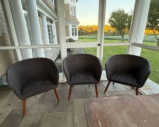 Woven Wicker Barrel Chairs -Set of 3: Dark brown woven wicker/rattan-style barrel chairs featuring rounded warp around backs and arms with tapered solid-wood legs. Clean, contemporary shape works beautifully in a screened porch, sunroom, covered patio or casual indoor space. Seat cushions included.