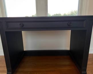 Pottery Barn black wood writing desk featuring a spacious center drawer, classic paneled detailing and substantial wood construction. Traditional design suitable for home office, bedroom or study.