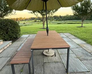 Crate & Barrel Alfresco Outdoor Dining Table & Bench | Contemporary C&B dining set featuring rectangular slatted faux-wood tabletop with coordinated bench and sleek black powder-coated aluminum frames. Designed for outdooer use with weather resistant materials and a center umbrella opening. Includes umbrella and stand.
