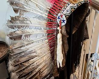 Native American Beaded Feather War Bonnet / Headdress Impressive full-size Native American feather war bonnet featuring an extensive arrangement of large feathers with red-wrapped quills, finely worked multicolor geometric beadwork, hide construction, long trailing hide elements, and white fur pendants. The piece shows considerable age and patina and appears to date to the mid-20th century or earlier. Tribal attribution, exact age, materials, and additional details to be determined upon further inspection. Price to be determined