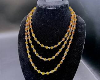 A 32" Continuous Strand Of Orange Colored Beads And A Pair Of Citrine Colored Clip-On Earrings
