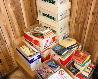 Book Collection Lot — Paperbacks, Cookbooks, and Arkansas Titles This book collection fills 10-plus boxes and spans paperback fiction, cookbooks, and regional interest titles. Visible authors include Jayne Ann Krentz, and visible titles include "Butter Busters: The Cookbook" and an Arkansas-themed book. The collection is packed in Boise paper boxes and EconoSource boxes, making for easy transport. A bulk book lot for resellers, readers, or donation — a strong variety of popular fiction and kitchen shelf titles in one pickup.