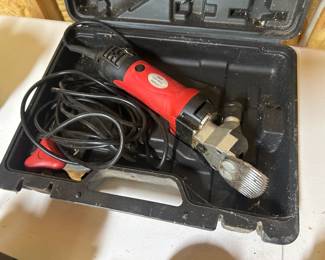 Electric Livestock Shears with Hard Case — 550W These electric livestock shears come in a fitted hard-sided carrying case with the motor unit, shearing head, and power cord. The label on the motor reads 550W, 110V, 2400 RPM, and the red-handled body shows use consistent with farm shearing work. Electric livestock shears are used for sheep, goats, alpacas, and large-dog grooming, and this 550-watt corded model provides steady power for full fleece removal. Working condition not confirmed — sold as found.