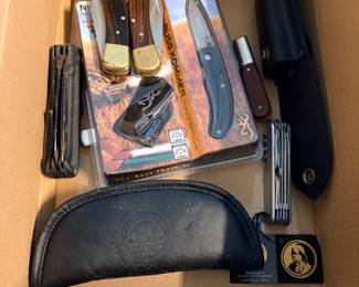 Knife Collection Lot — Browning, Fixed Blades, and Multi-Tools This knife collection lot includes a Browning Russ Kommer designed folding knife still in its original retail packaging, two fixed-blade knives with wood and brass bolster handles, a Barlow-pattern folding pocket knife, a Swiss Army-style multi-tool, a black folding multi-tool, and two leather belt sheaths — one bearing a Franklin Mint Collectors embossed seal. A solid knife collector lot with branded and classic-style pieces for hunting, EDC, and display.