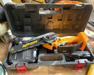 This 20V Max Lithium cordless mini chainsaw comes complete in its molded carrying case with a lithium-ion battery pack and charger. The compact one-handed design with a short guide bar makes it ideal for pruning, limbing, and light cutting tasks around the yard. The orange and black housing shows minimal use, and all original components appear present in the fitted case. Working condition not confirmed — sold as found.