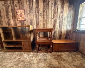 Wood Furniture Lot — Bookshelf, End Table, and Blanket Chest This wood furniture lot includes three pieces: a standard bookshelf suitable for paperbacks and display items, a turned-leg end table with a traditional silhouette, and a blanket chest or cedar chest with drawer-pull hardware on the front. All three pieces show used household condition with surface wear appropriate to their age. A practical furniture lot for furnishing a bedroom, den, or guest room in one bid.