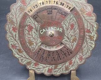 Perpetual brass desktop calendar.