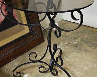 Glass topped, scrolled metal table
