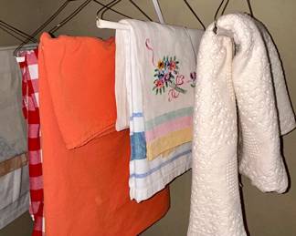 Assorted linens: towels, embroidered tea towel, blanket