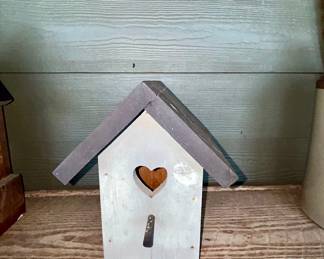 Handmade wooden birdhouse with heart cutout