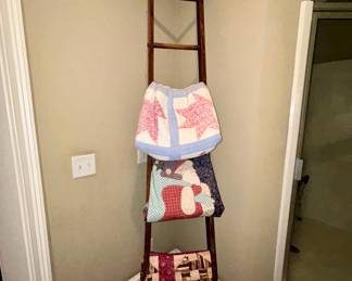 Wooden quilt ladder with 3 patchwork quilts