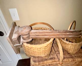 Assorted woven wicker baskets, antique wood wall-mounted swing arm