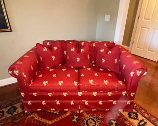 Red floral print upholstered loveseat with throw pillows - $100