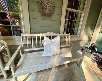 Weathered wood porch bench with slat back