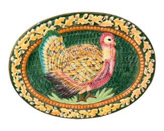 stoneware Thanksgiving turkey serving platter featuring a raised, hand-painted turkey design with a textured green center and an acorn-and-leaf border