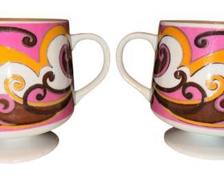 vintage 1968 Holt-Howard pedestal mug. Manufactured in Japan, this footed, stackable ceramic cup features a quintessential mid-century modern psychedelic swirl pattern in vibrant shades of pink, brown, white, and orange.