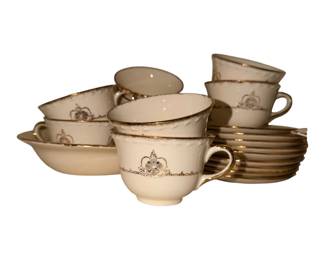 a vintage set of creamy-white porcelain teacups and saucers with 22-karat gold trim, resembling the CRO9 pattern by the Crooksville China Co