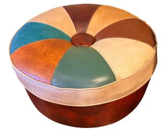 MCM round, multi-colored faux leather or vinyl pouf ottoman, styled with a segmented geometric pattern and a central button tuft