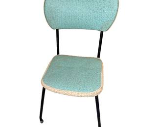 vintage 1950s or 1960s mid-century retro metal kitchen and dining chair featuring teal or seafoam green patterned vinyl upholstery
